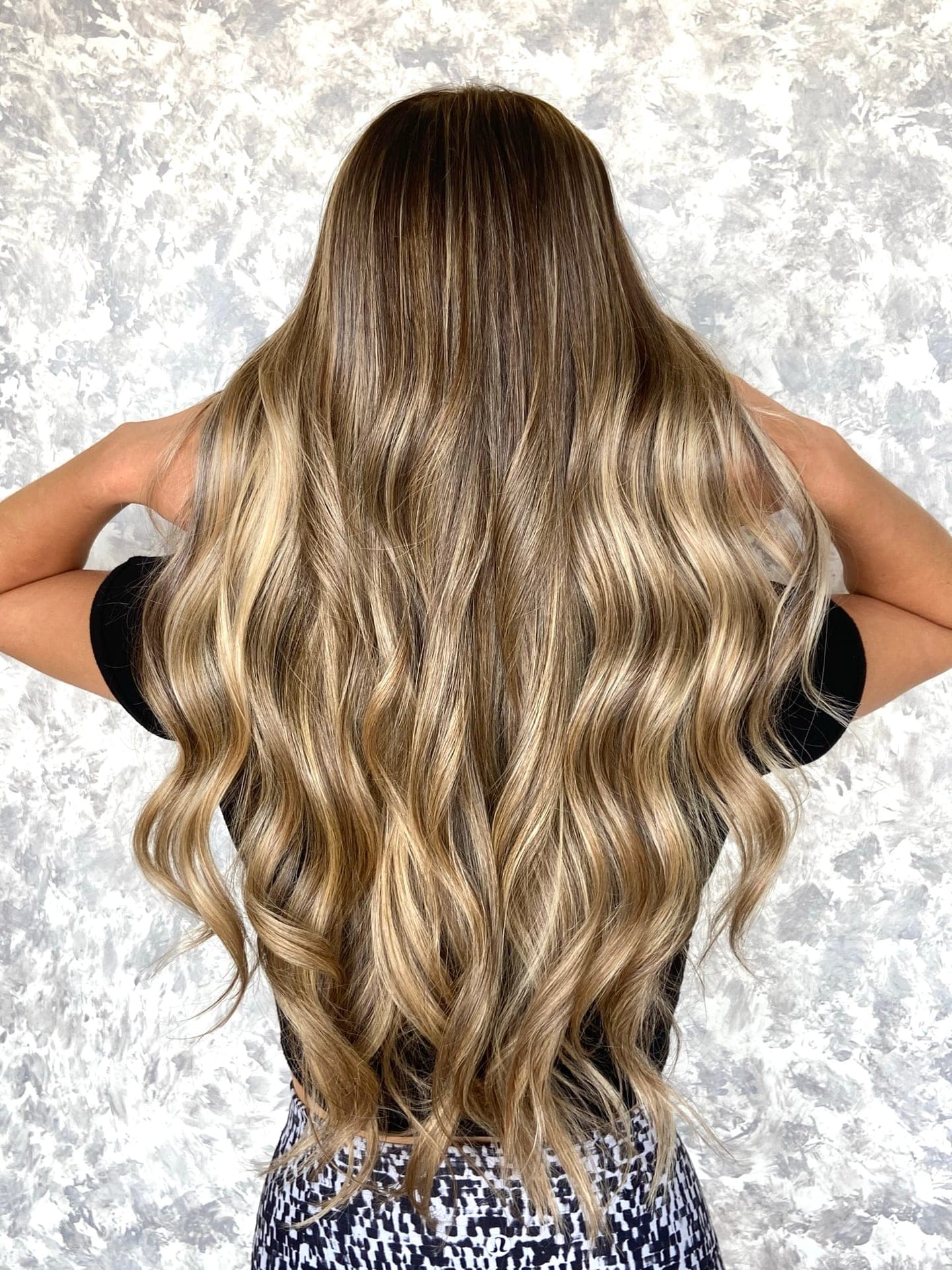 Long dimensional blonde — a root shadowed base grown out into bright blonde balayage waves